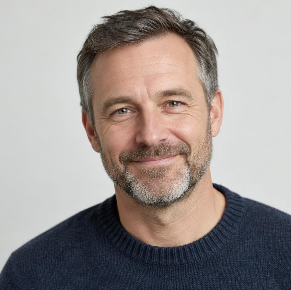 Portrait of a German man with a short beard wearing a sweater