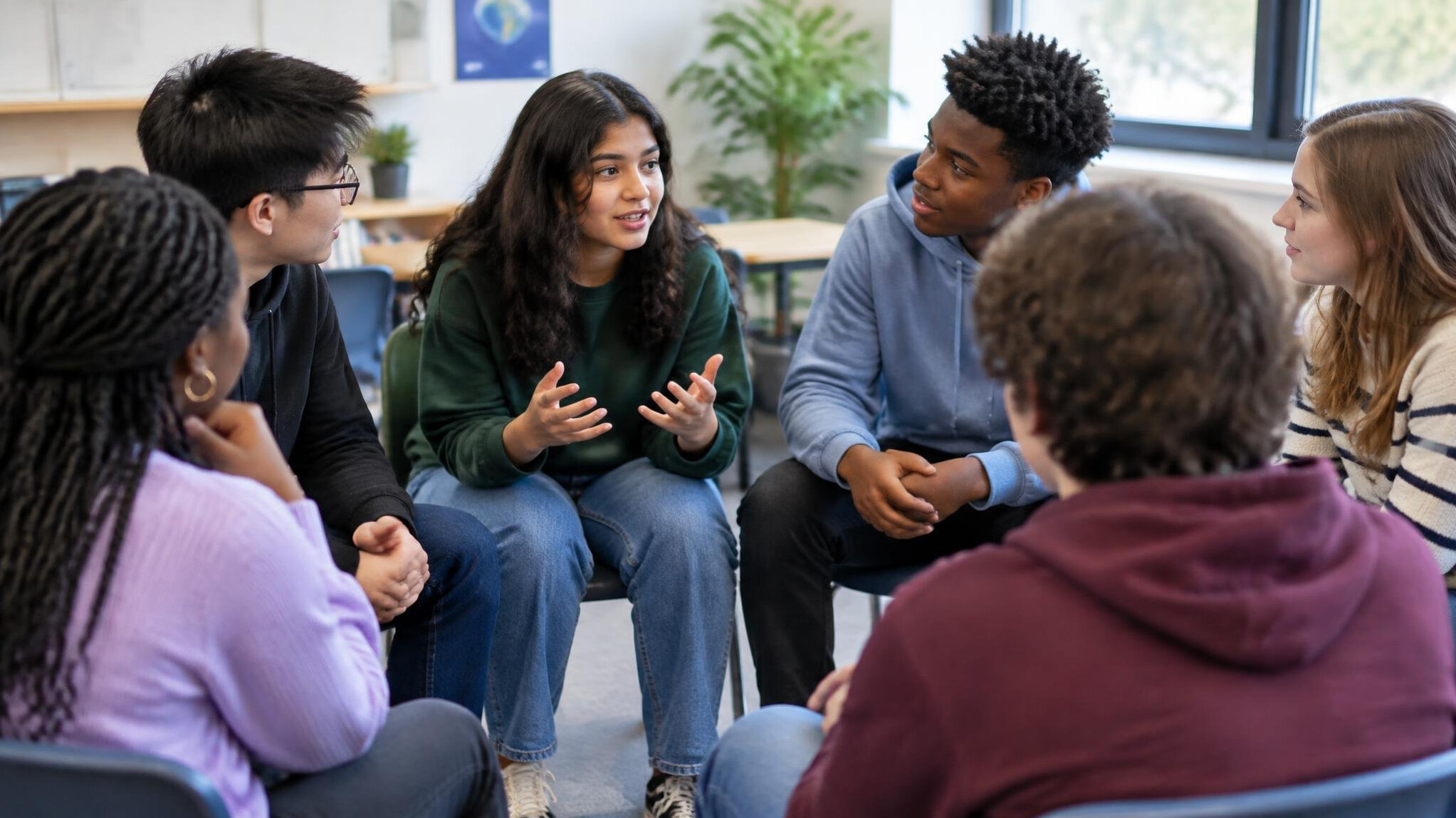 diverse young people discussing in circle