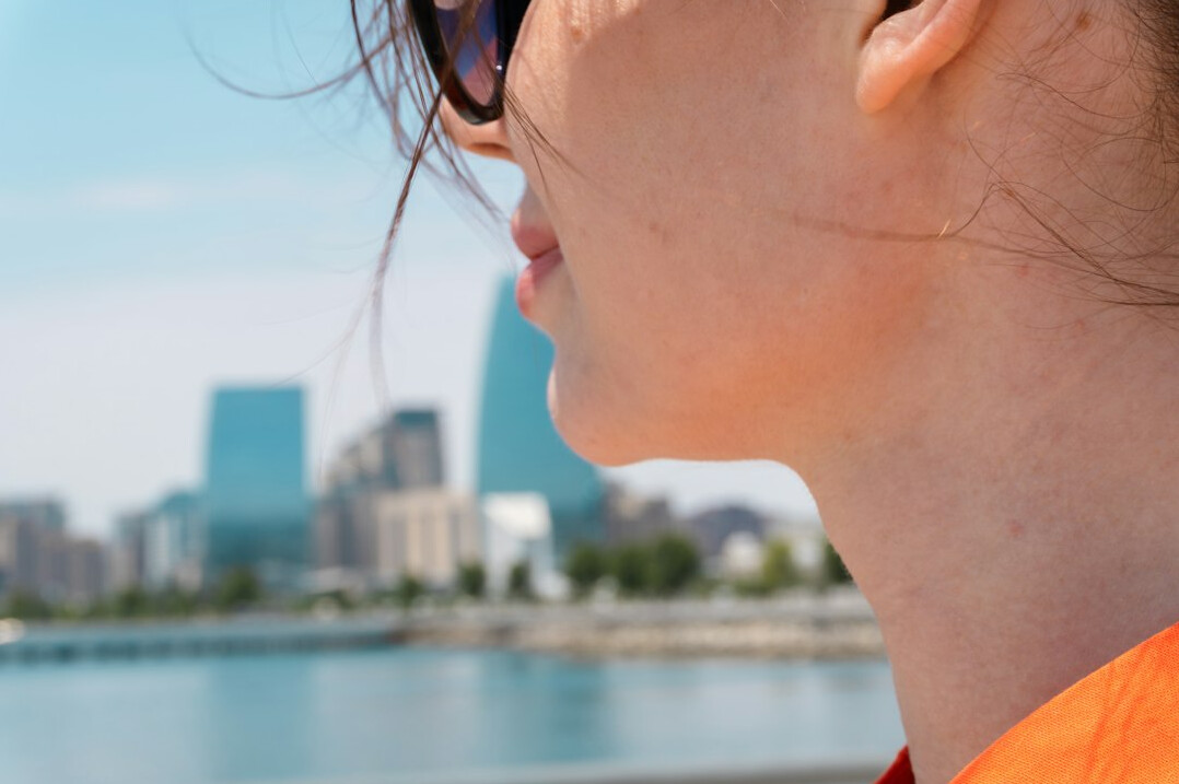young woman looking at city skyline