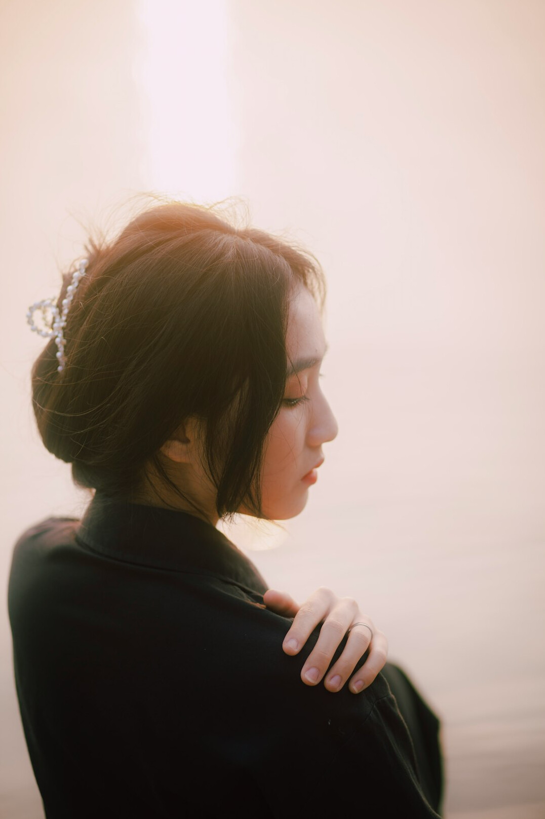 Portrait of a young woman with dark hair tied back wearing a blazer